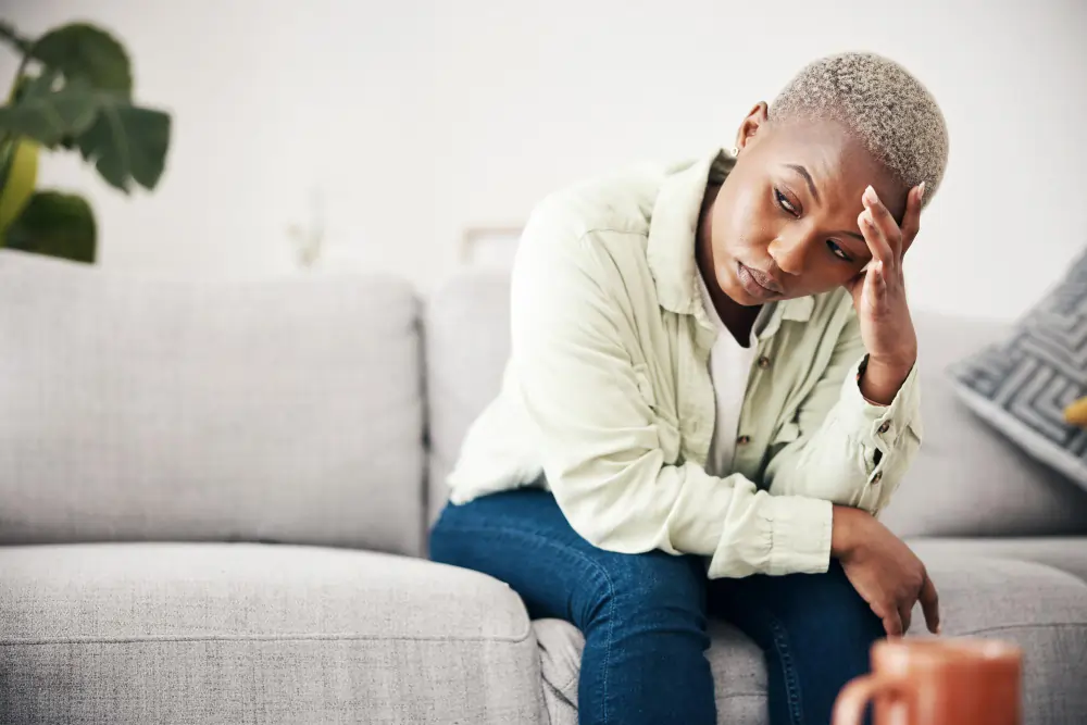Woman depression and thinking in home of pain mental health or anxiety of debt regret or risk stress worry and frustrated african person with headache of sad trauma broken heart